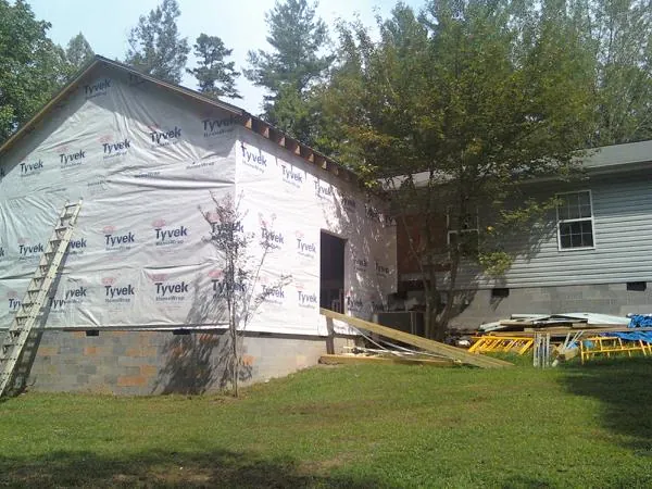 Tyvek wrapped gable on a new room addition beside an existing home in Kellogg